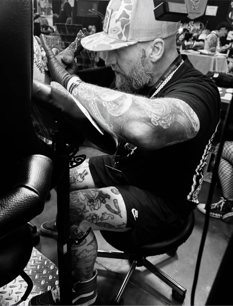 Eric Bryant tattooing at a convention