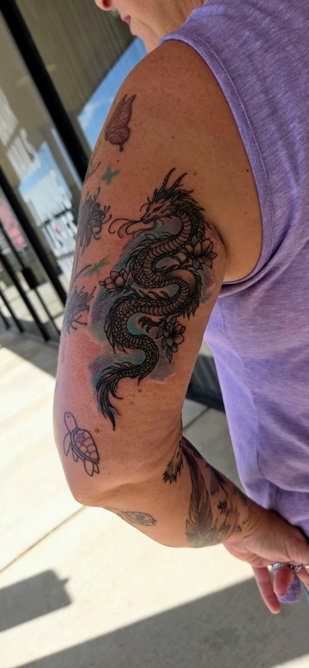 Illustrative color dragon tricep tattoo by Wesley Herring